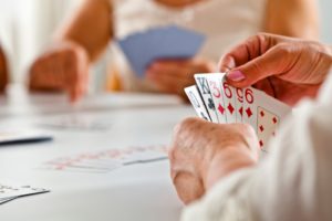 retired elderly residents playing games at assisted living or memory care home
